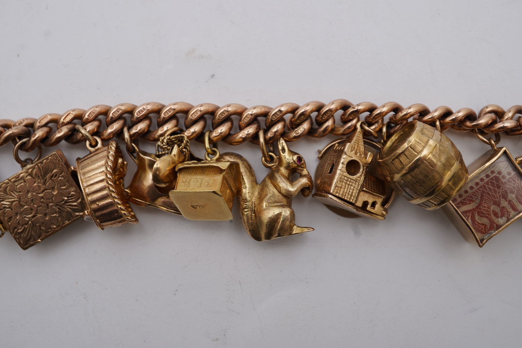 A 9ct gold charm bracelet, mid 20th century